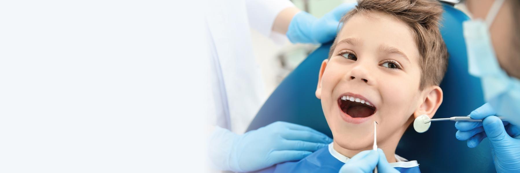 Boy smiling during dental exam with childrens dentist in Greeley CO
