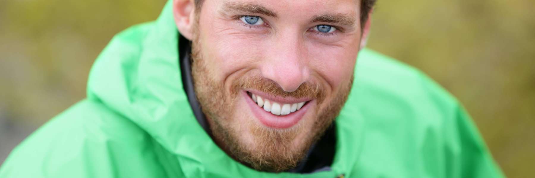 A smiling man in the park | Greeley dentist