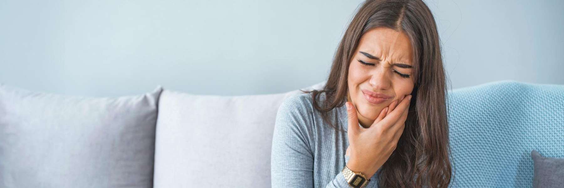 A woman with a toothache | tooth pain Greeley
