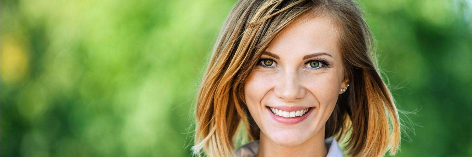 A smiling woman in the park