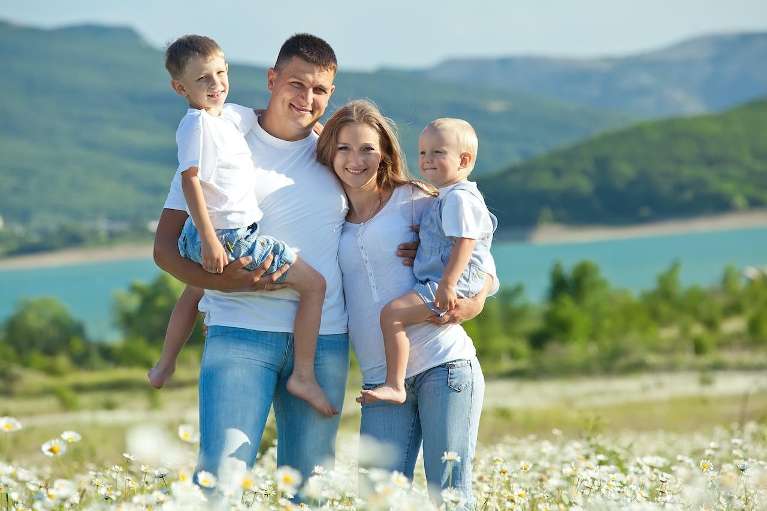 A smiling family at the lake