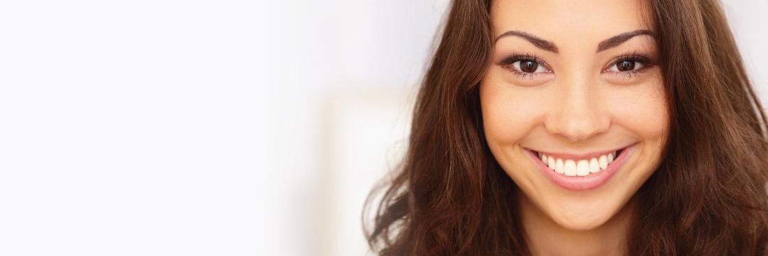 Woman smiling at dentist office in West Greeley CO
