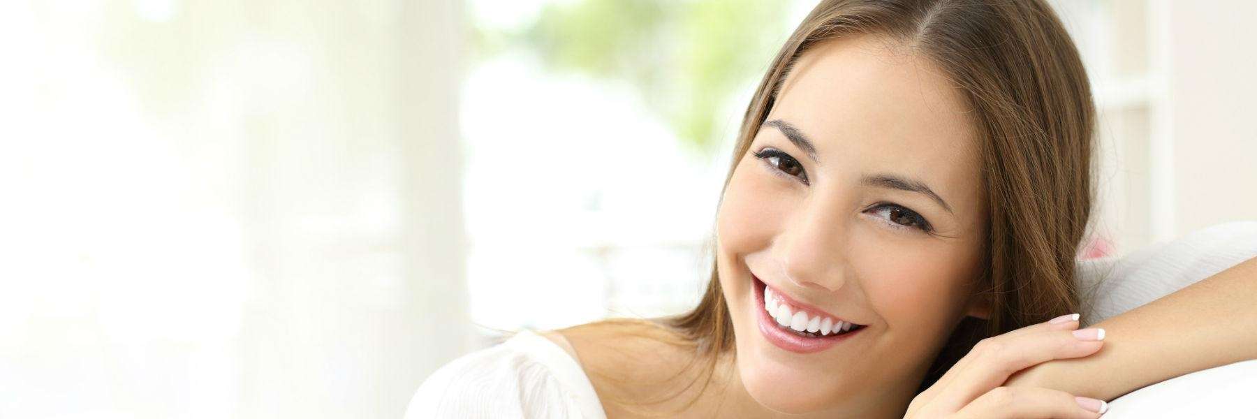 A smiling woman with professionally whitened teeth in Greeley