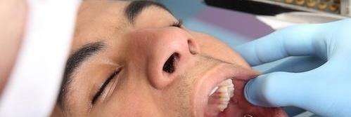 Close up of man getting dental exam by dentist in Greeley CO